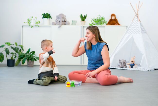 Nonverbal child learning to sign with the help of a speech therapist