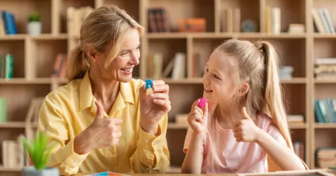 speech therapist assisting her child patient